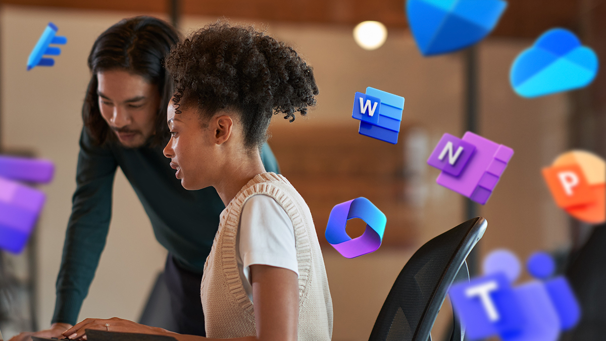 Two coworkers looking at a computer together. Icons of Microsoft 365 products surround the people on the image.