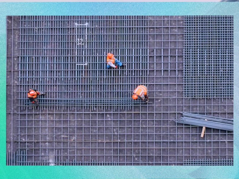 Aerial view of construction workers in on a foundation of rebar.